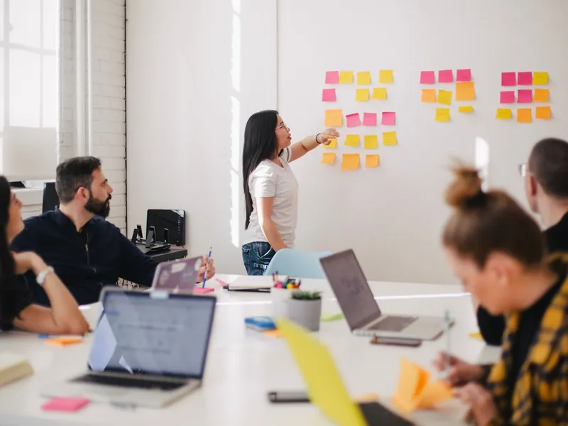 Marketing team collaborating around a table while planning a campaign